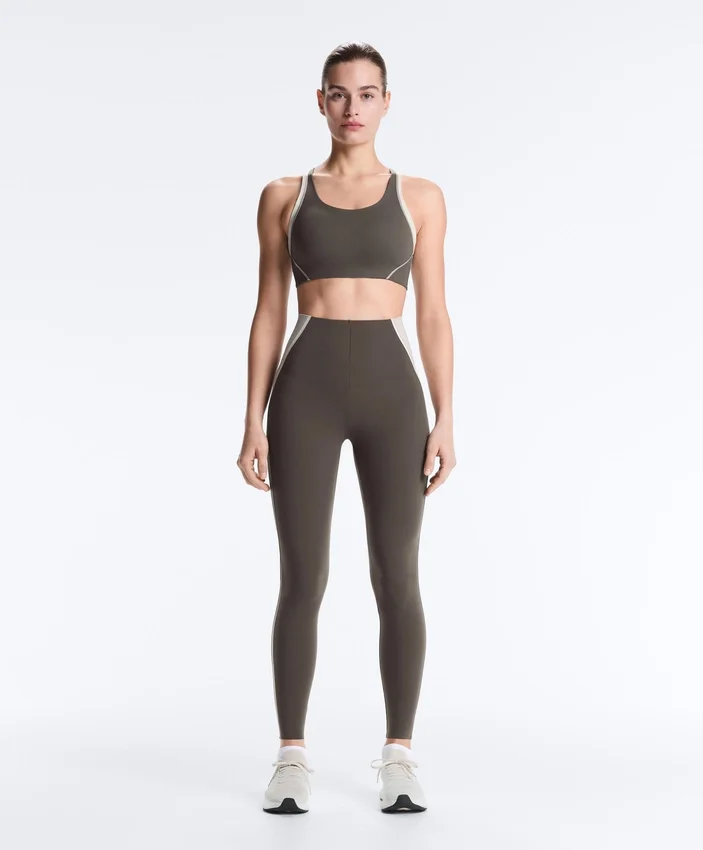 Compressive sports bra with firm support and reflective elements Compressive sports bra with firm support and reflective elements
